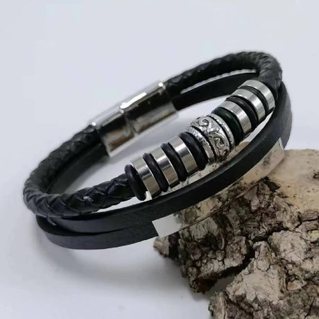 Black leather bracelet with silver beads on a white background