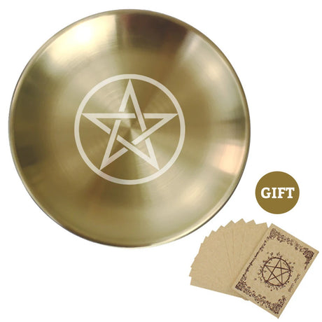 Gold dish with pentagram design and brown cards on a white background