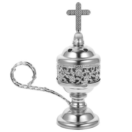 Decorative silver object with a cross on top against a white background