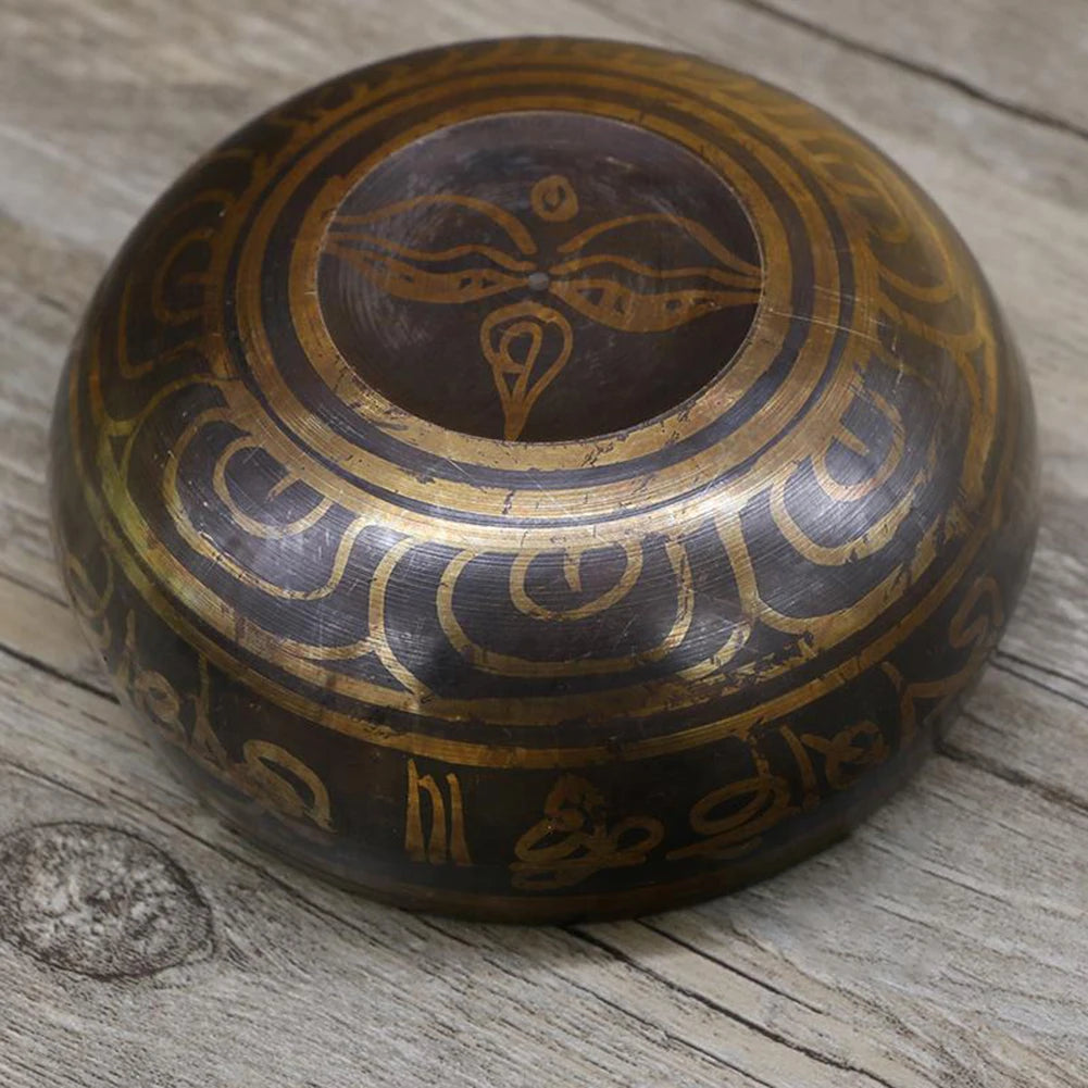 Decorative wooden bowl with intricate carvings on a wooden surface