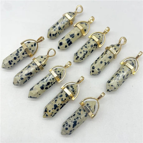 Set of stone pendants with gold accents on a white background