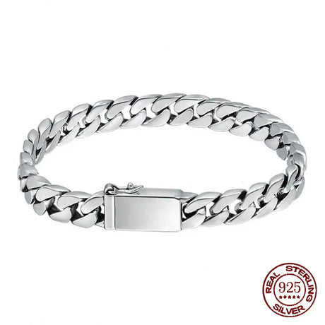 Silver chain bracelet with a clasp on a white background, featuring 'Real Sterling Silver' stamp.