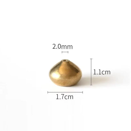 Gold bead with measurements on a white background