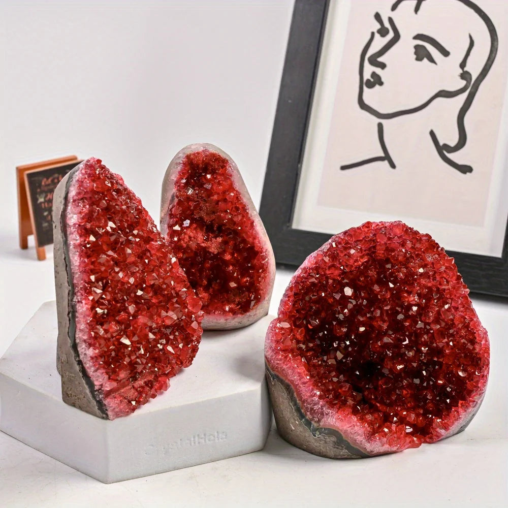 Red geode bookends on a white surface with a framed picture in the background