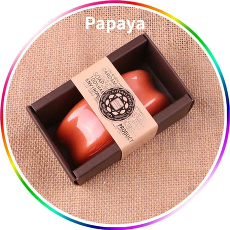 Red soap bar in a brown box with a label on a textured beige background, labeled 'Papaya'.