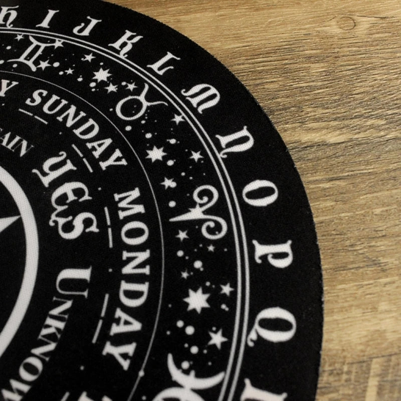Black and white astrological wheel on a wooden surface