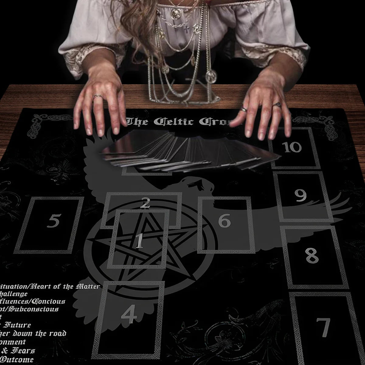 Person with tarot cards on a Celtic Cross mat