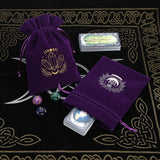 Purple velvet bags with crystal design on a black and gold patterned surface