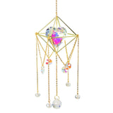 Decorative hanging crystal with gold frame and colorful beads on a white background