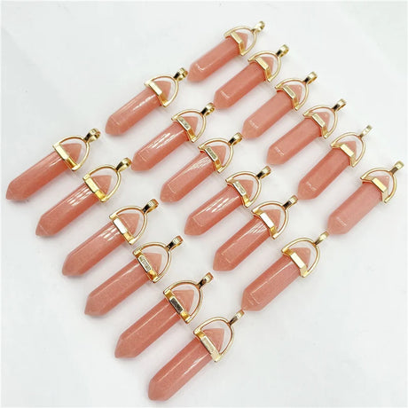 Pink crystal pendants with gold accents on a white background