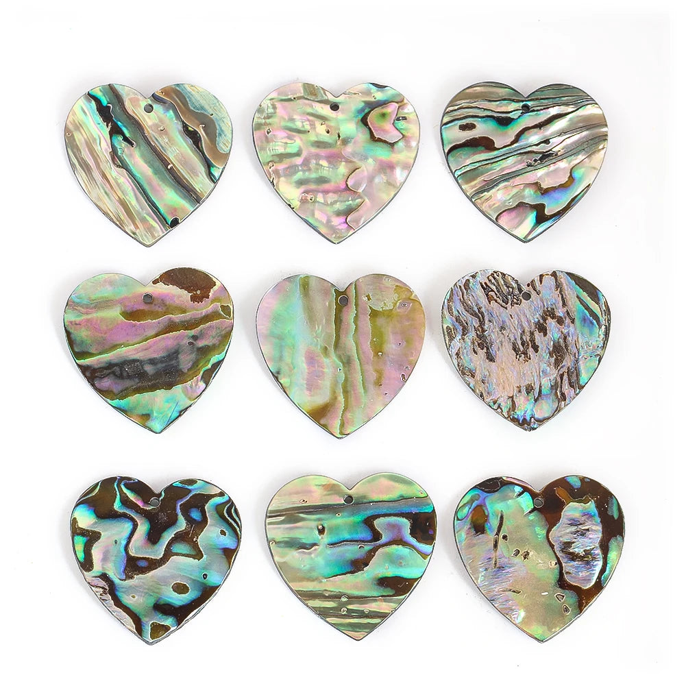 Heart-shaped abalone shell pendants on a white background