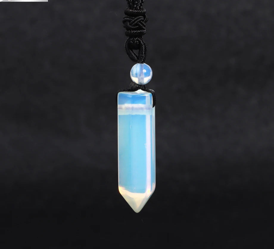 Blue crystal pendant necklace on a dark background