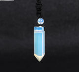 Blue crystal pendant necklace on a dark background