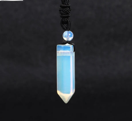 Blue crystal pendant necklace on a dark background