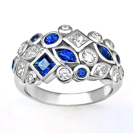 Silver ring with blue and clear gemstones on a white background