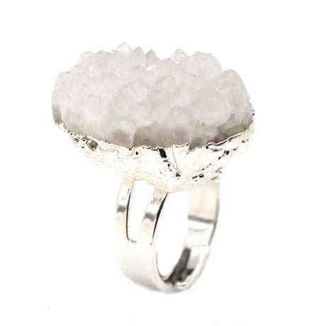 Silver ring with a large, textured stone on a white background