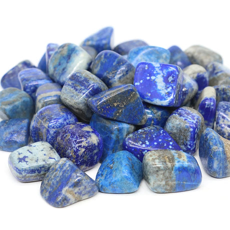 Collection of blue and gray tumbled stones on a white background
