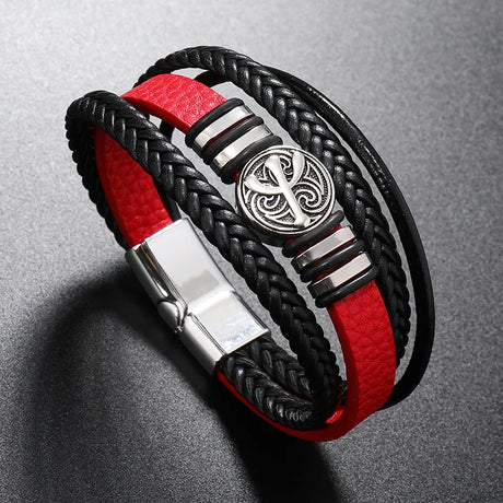 Bracelet with black and red braided design and silver clasp on a gray background