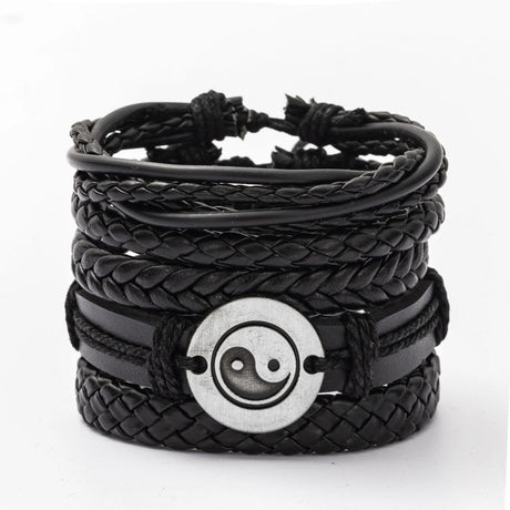 Black braided leather bracelet with a silver yin yang symbol on a white background