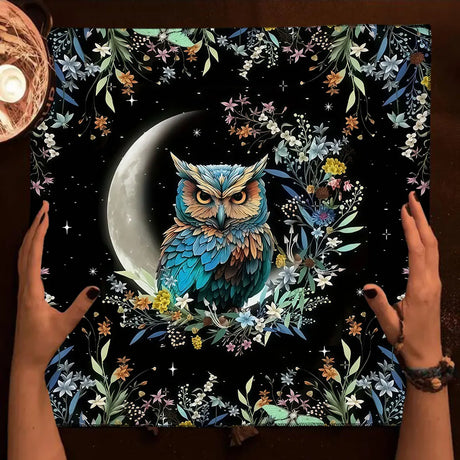 Floral and owl design on a dark background with hands holding it