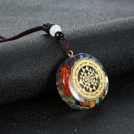 Decorative pendant with intricate design on a dark surface