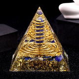 Pyramid-shaped object with gold and blue elements on a black background