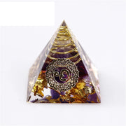 Pyramid-shaped object with a decorative emblem on a white background