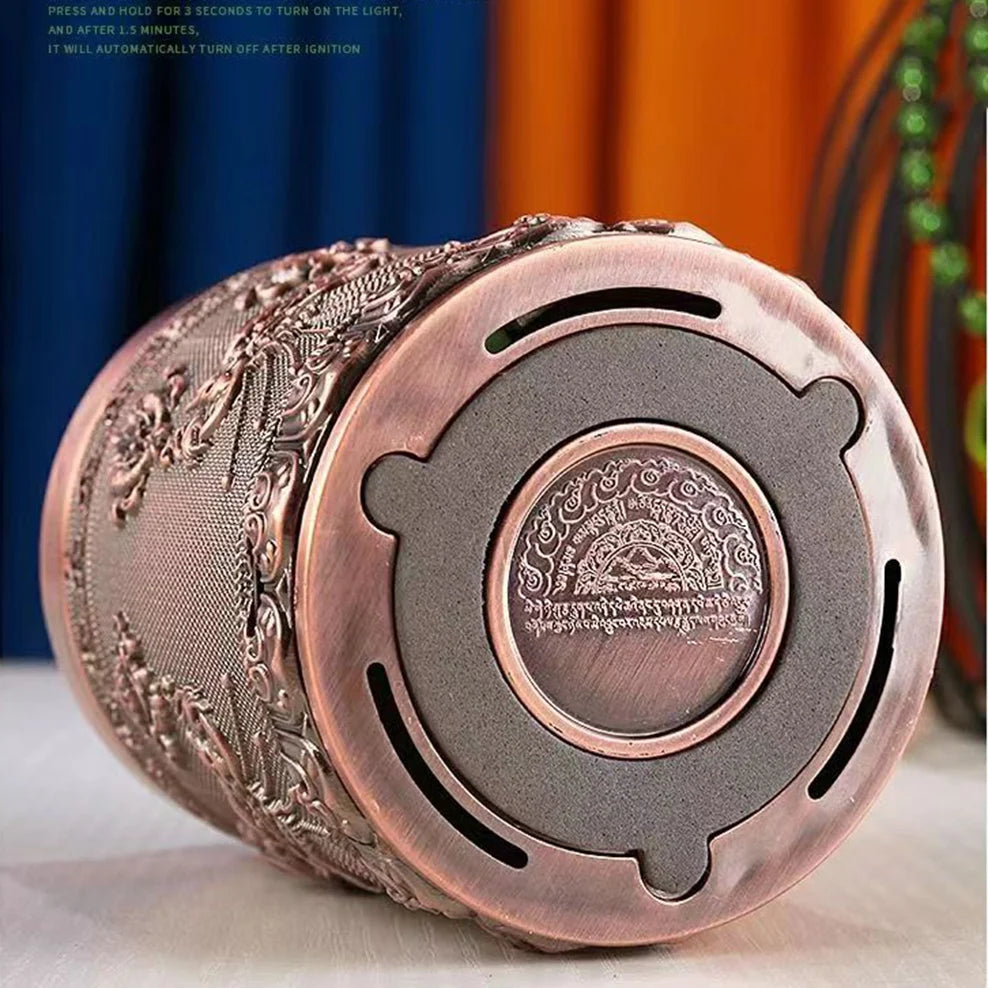 Decorative metal lighter with intricate designs on a white surface