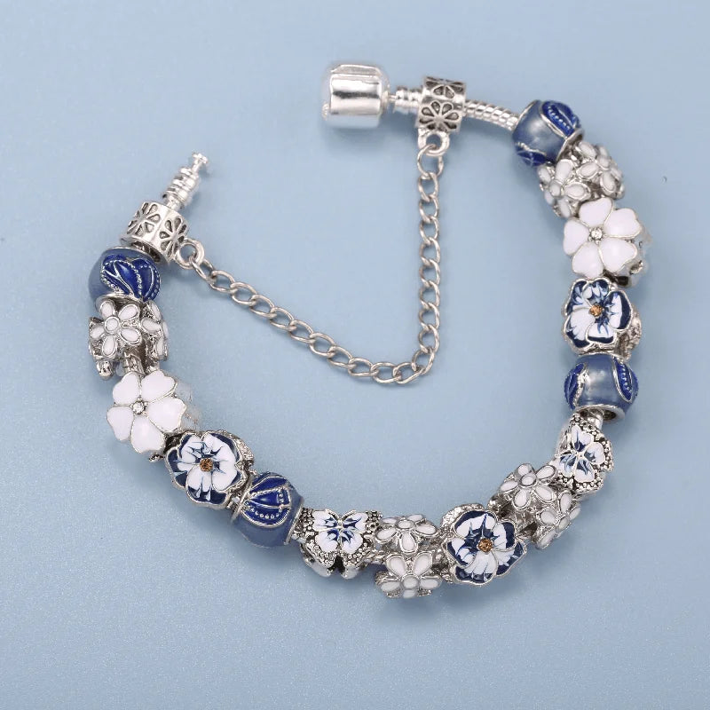 Bracelet with blue and white floral beads on a light blue background