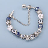 Bracelet with blue and white floral beads on a light blue background