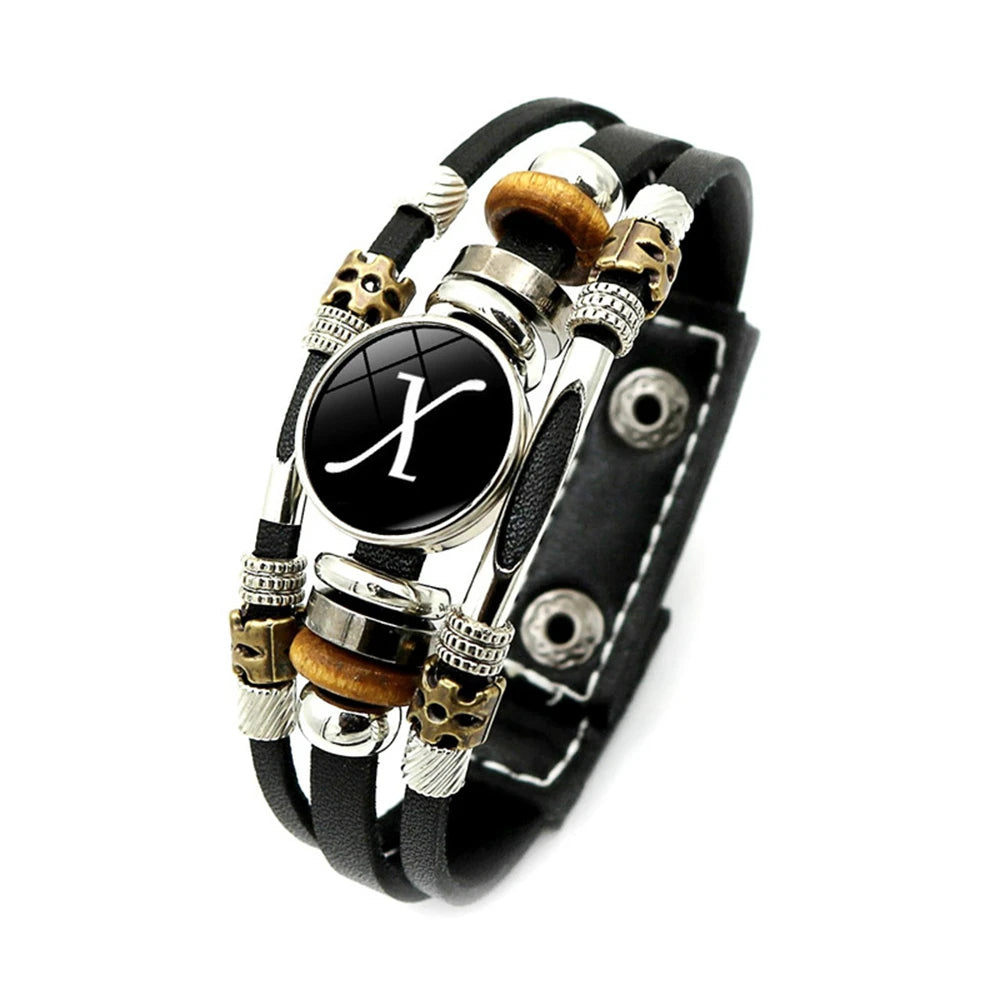 Multistrand bracelet with black leather strap and decorative beads on a white background