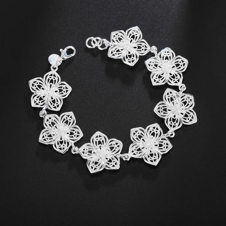 Silver floral bracelet on a black background