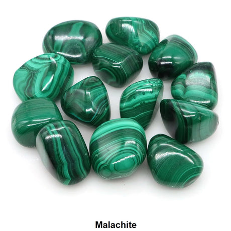 Collection of green malachite stones on a white background