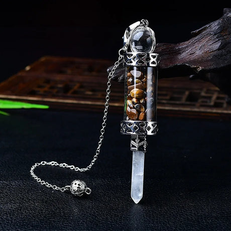 Decorative crystal pendant with chain on a dark background