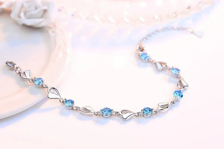 Silver bracelet with blue gemstones on a light background