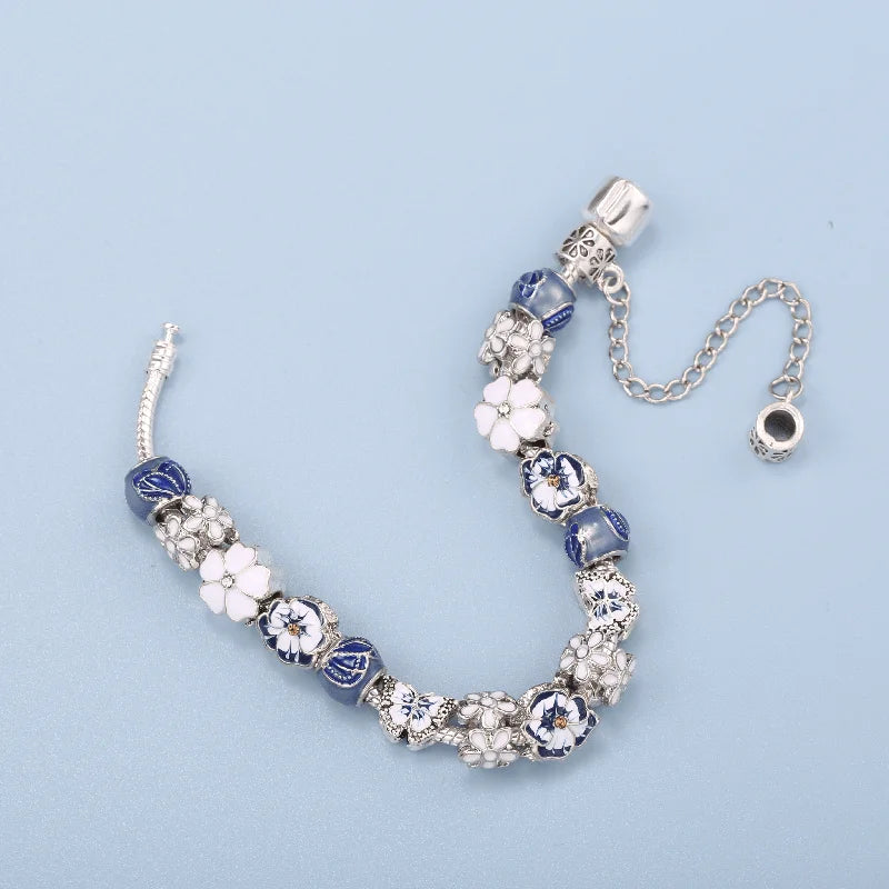 Beaded bracelet with floral and crystal designs on a light blue background