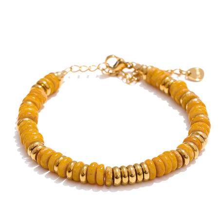 Yellow beaded bracelet with gold accents on a white background
