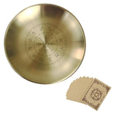 Gold dish with engraved symbols and a set of matching cards on a white background