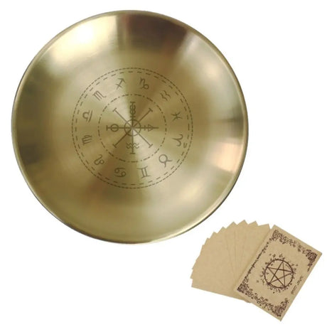 Gold dish with engraved symbols and a set of matching cards on a white background