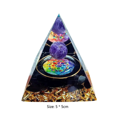 Triangular pyramid with colorful crystal ball and decorative elements on a white background