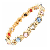 Gold bracelet with colorful heart-shaped gemstones on a white background