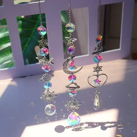 Decorative earrings with colorful beads and celestial charms on a light background.