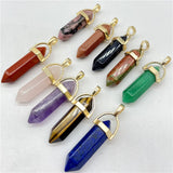 Collection of crystal pendants with gold accents on a white background