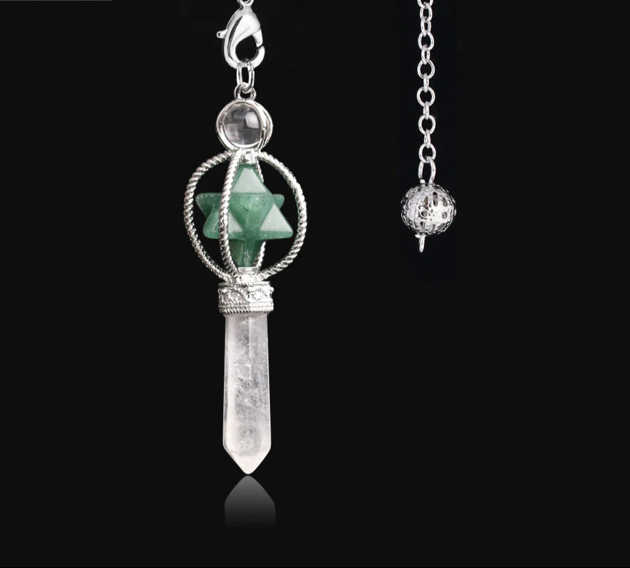 Jewelry pendant with green stone and silver chain on a black background