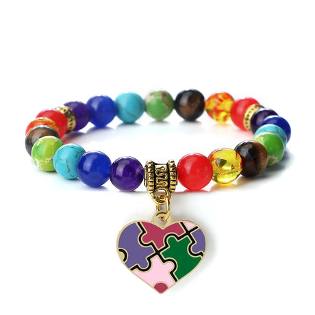 Colorful beaded bracelet with a heart-shaped puzzle piece charm on a white background