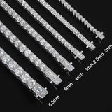 Set of silver chains with varying widths on a black background