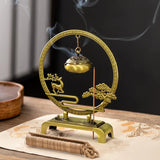 Decorative incense burner with smoking incense on a wooden surface