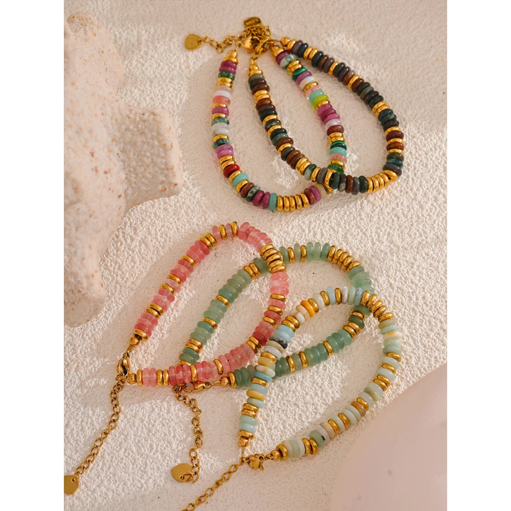 Colorful beaded necklaces on a textured surface
