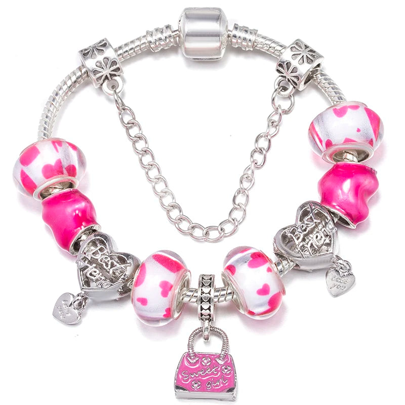 Bracelet with pink and white heart-themed beads and silver charms on a white background