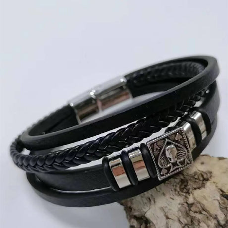 Black leather bracelet with metal accents on a white background